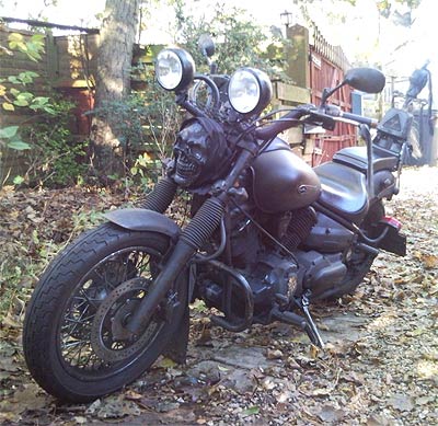Motorcycle with skull mounted below dual headlamps